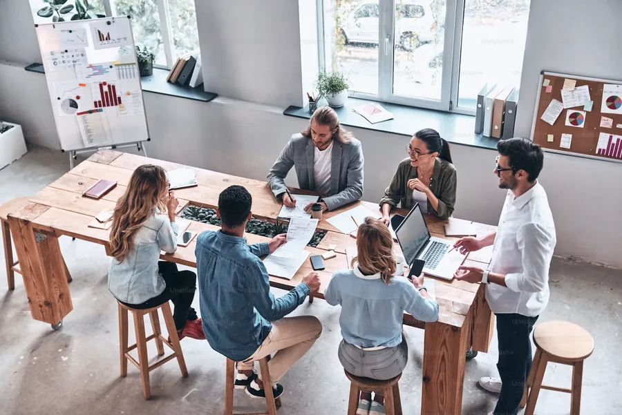 Team collaborating around a shared workspace in a modern office