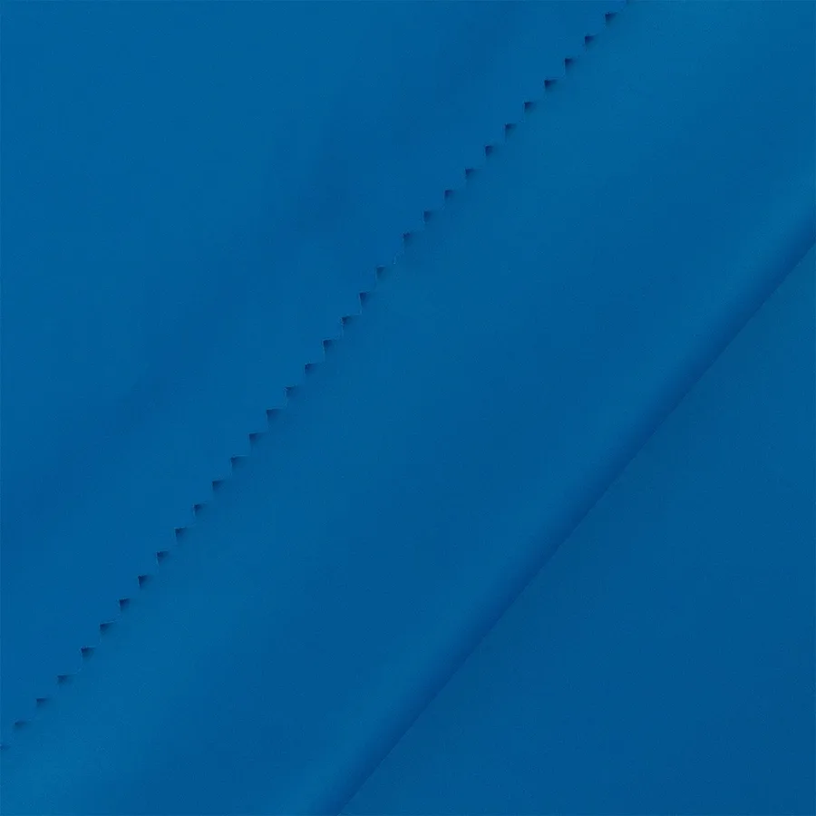 Blue fabric with a diagonal pinking-shear seam, D&S Fashion product photography
