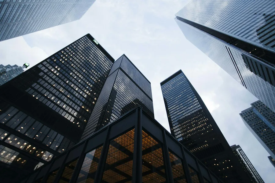 Modern corporate office towers in a global business district, illustrative photography